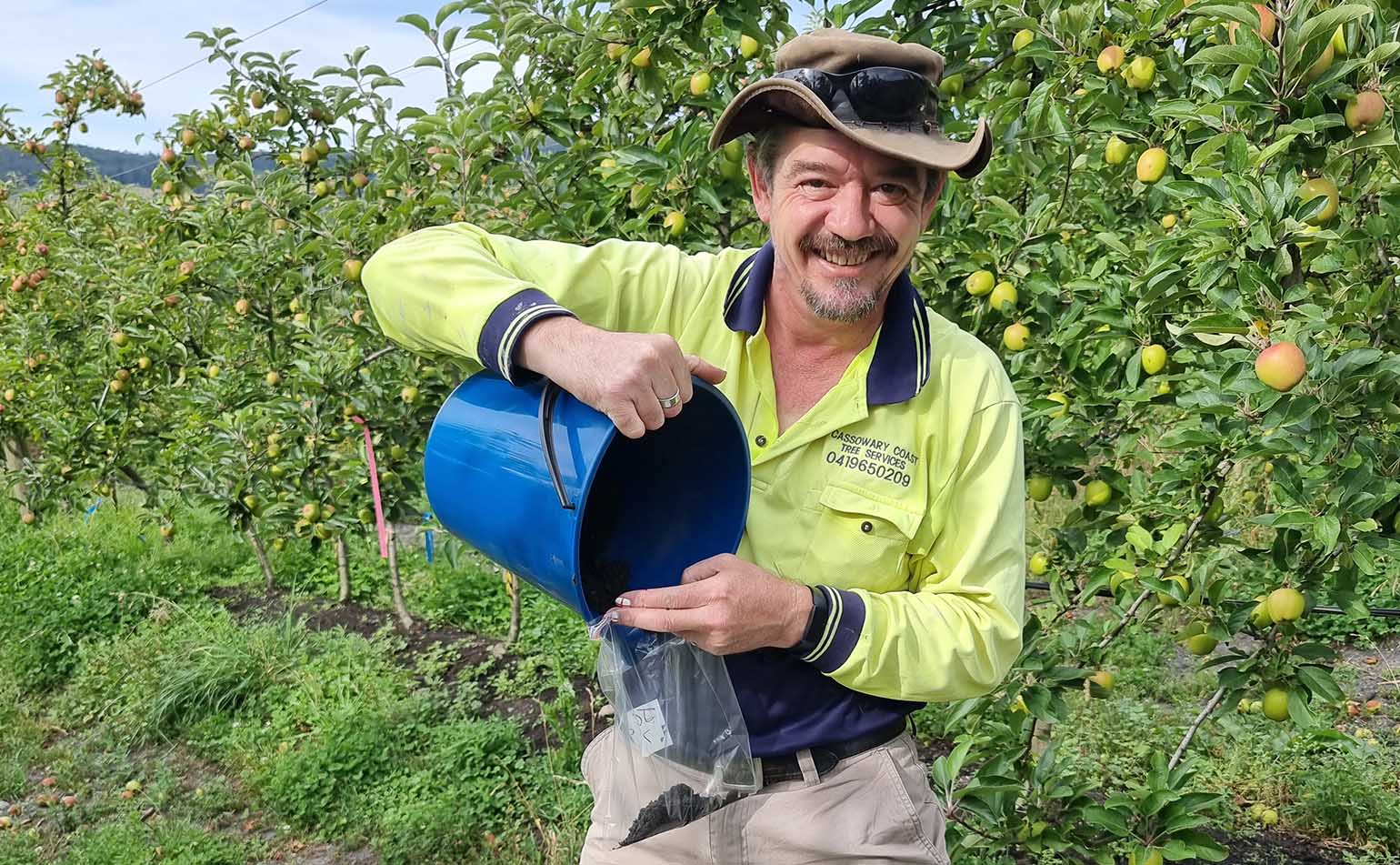 Phil Kay collecting soil samples in an orchard