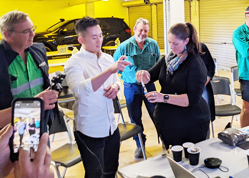 Soil CRC PhD student Reuben Mah demonstrates microfluidic device to farmer group