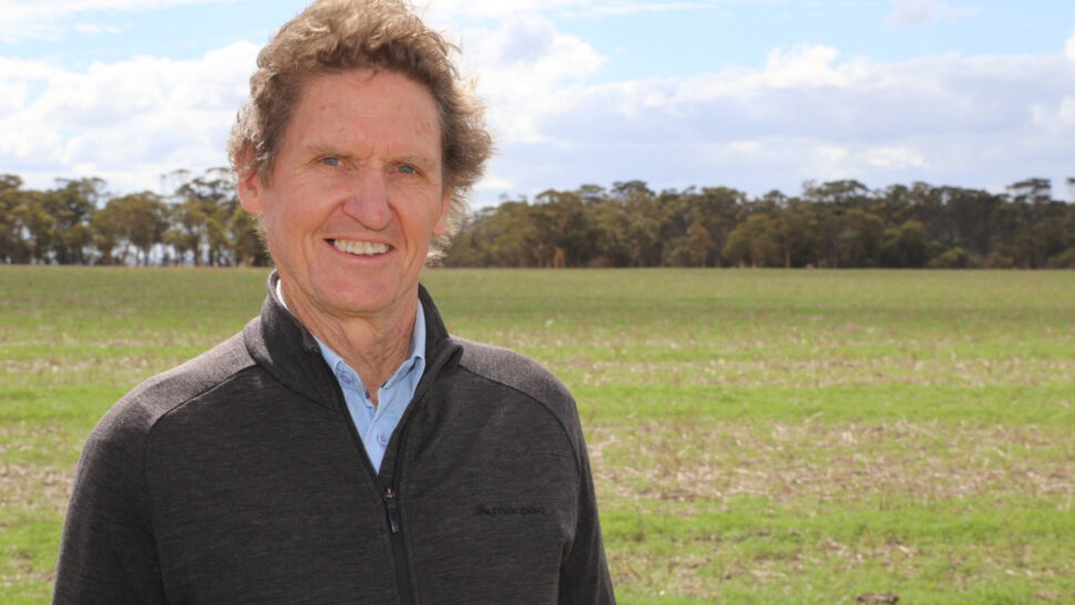 Emeritus Professor Richard Bell standing in a field and smiling at the camera.