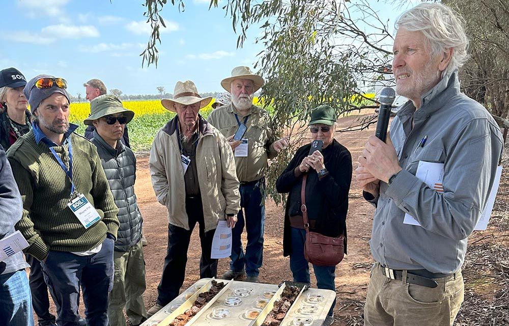 Richard presenting at a field trip, discussing soil samples